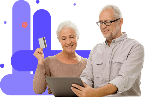 Senior couple using tablet and holding credit card for dental services